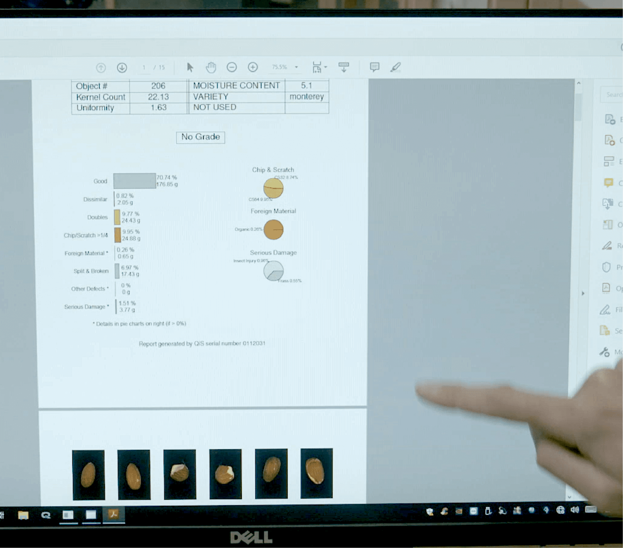 closeup of finger pointing to data sheet with images of different types of almond conditions and grade charts and scales in percentages